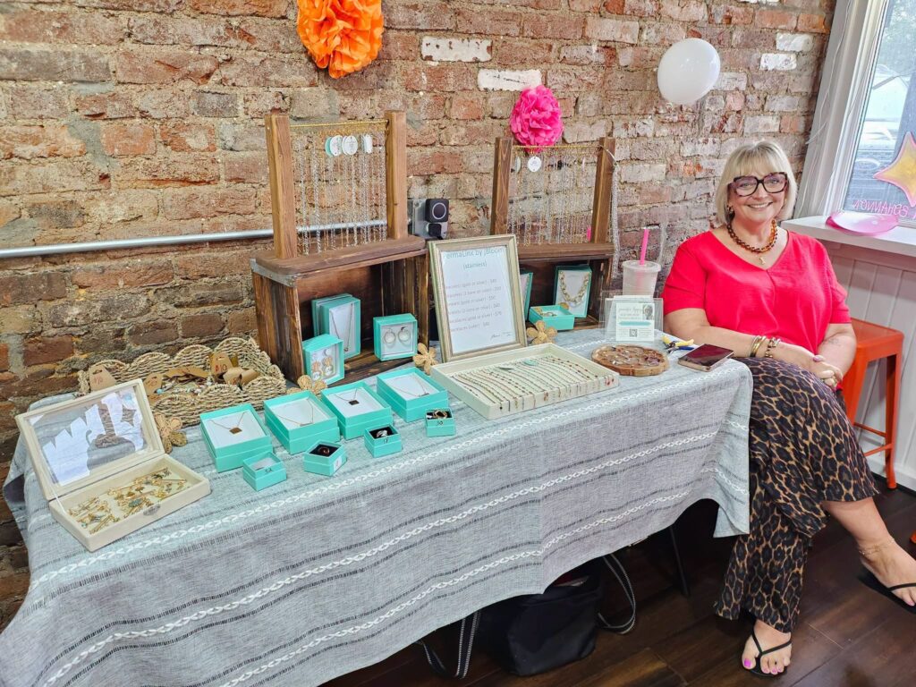 Jennifer at her Blooming in Pieces jewelry pop-up table