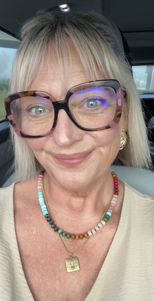 Jennifer Lippy wearing a colorful beaded necklace with a gold charm