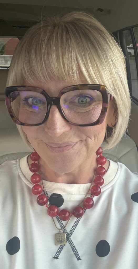 Jennifer Lippy wearing a red beaded statement necklace